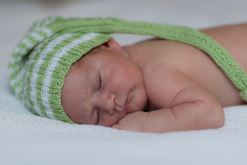 baby sleeping SM with cap on shutterstock_153888116